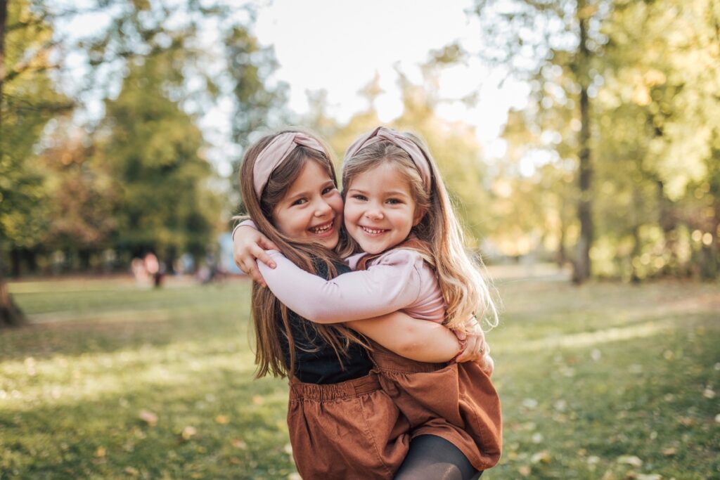 tooth colored fillings central park pediatric dentistry girls hugging